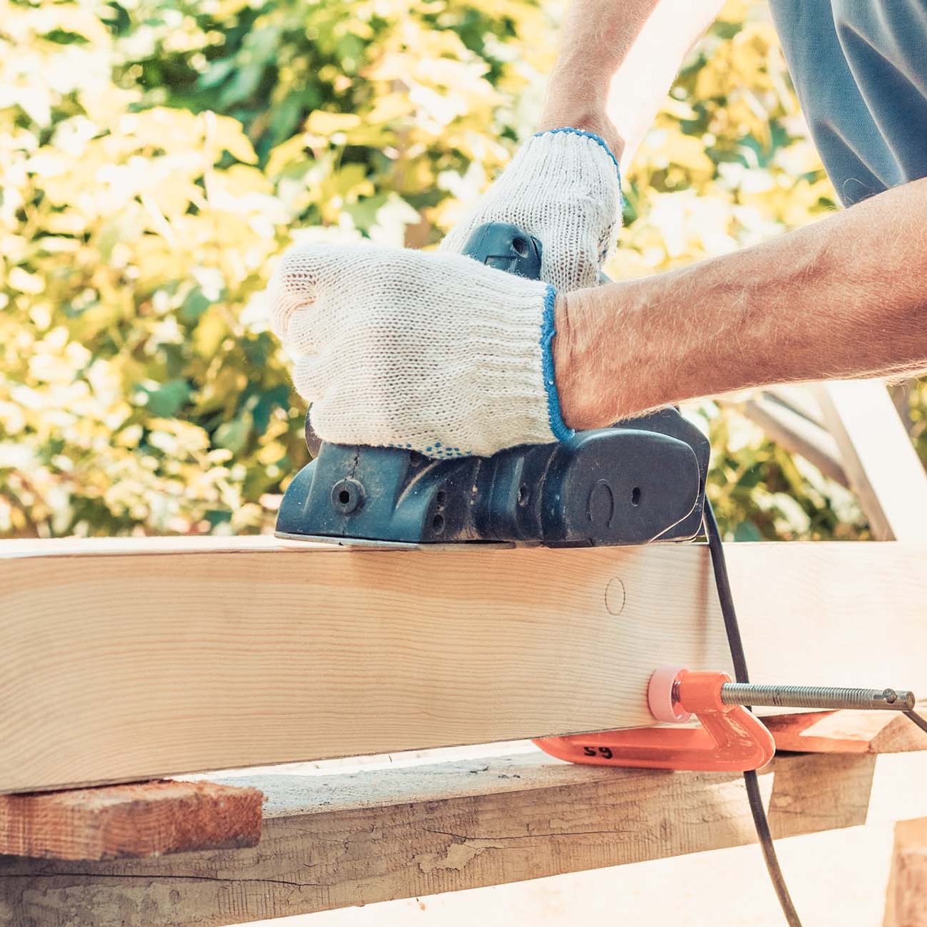 Hero3 Cropped Image Of Carpenter Measuring Wood At. Cropped image of senior carpenter measuring wood at tablesaw in workshop